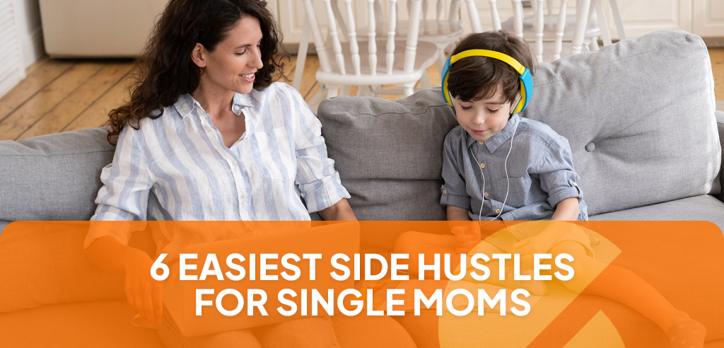 Single mom sitting on a couch next to her son and working on an easy side hustle on her laptop