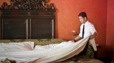 Shift worker cleaning a hotel room.