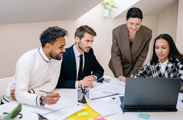 Professional consultant showing three clients paperwork with data and performance insights