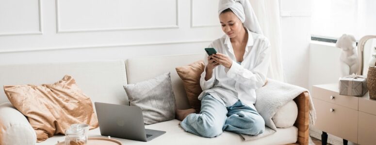 Woman relaxing on her couch playing Freecash for money.