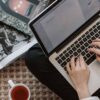 Close view of a freelance writer browsing a job board on their laptop.