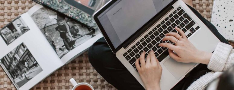 Close view of a freelance writer browsing a job board on their laptop.