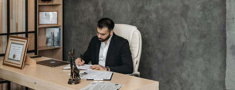 Consultant sitting at a desk and writing down notes from a consulting job