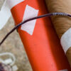 Close view of a donor's arm as they give blood plasma at a clinic.