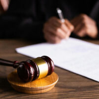 Close view of a judge reviewing a document that's been checked by a transcript proofreader.