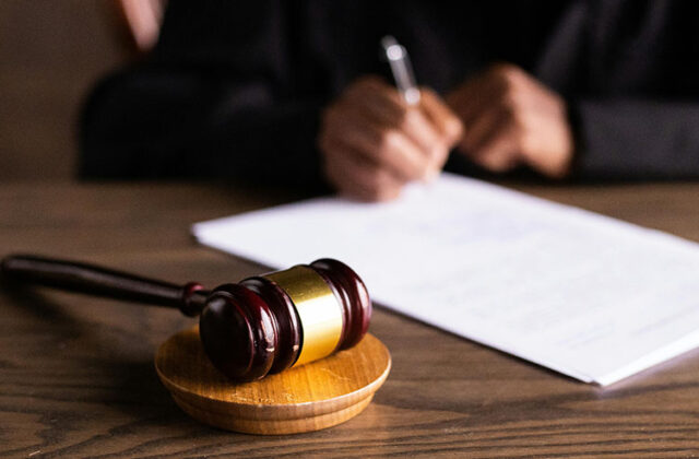 Close view of a judge reviewing a document that's been checked by a transcript proofreader.