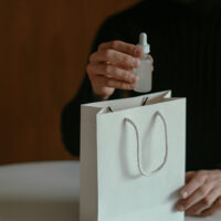 Close view of an Amazon product tester holding a bag with free products in it.