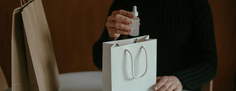 Close view of an Amazon product tester holding a bag with free products in it.