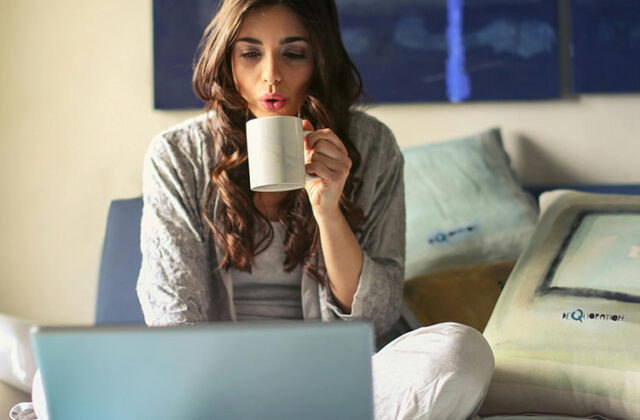 Woman sitting at her laptop using a microtask website to earn money.