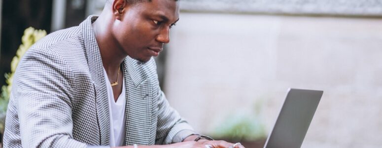 Man sitting at his laptop hunting for a job using automated AI tools.