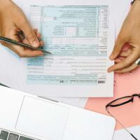 Close view of an IRS form as an Uber driver files their taxes.