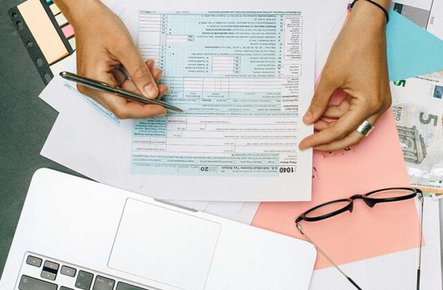 Close view of an IRS form as an Uber driver files their taxes.