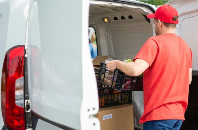 Upshift gig worker unloading a crate from a van.