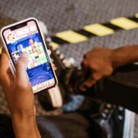 Close view of someone holding a phone with a pay-for-cash game on the screen.