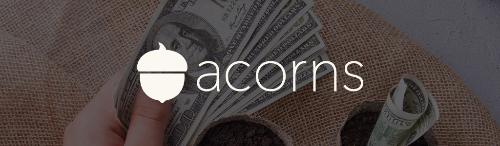 Acorns logo against a background of fanned out cash