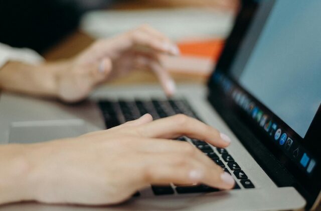 Close view of a woman searching for a job with AI on her laptop.