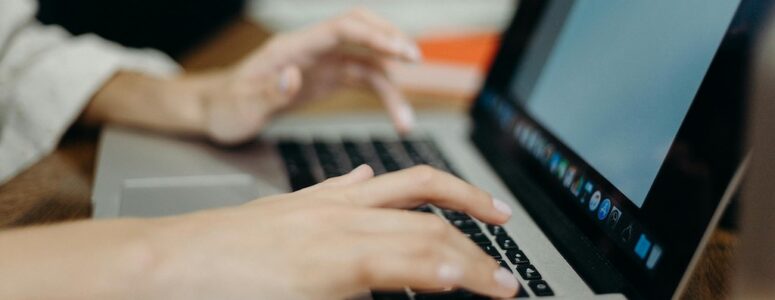 Close view of a woman searching for a job with AI on her laptop.