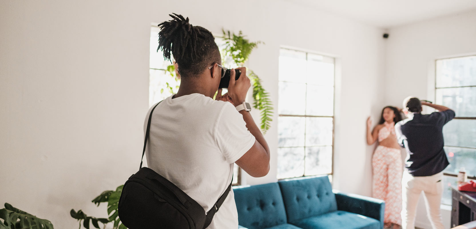 Assistant helping a photographer out with a shoot in a client's home