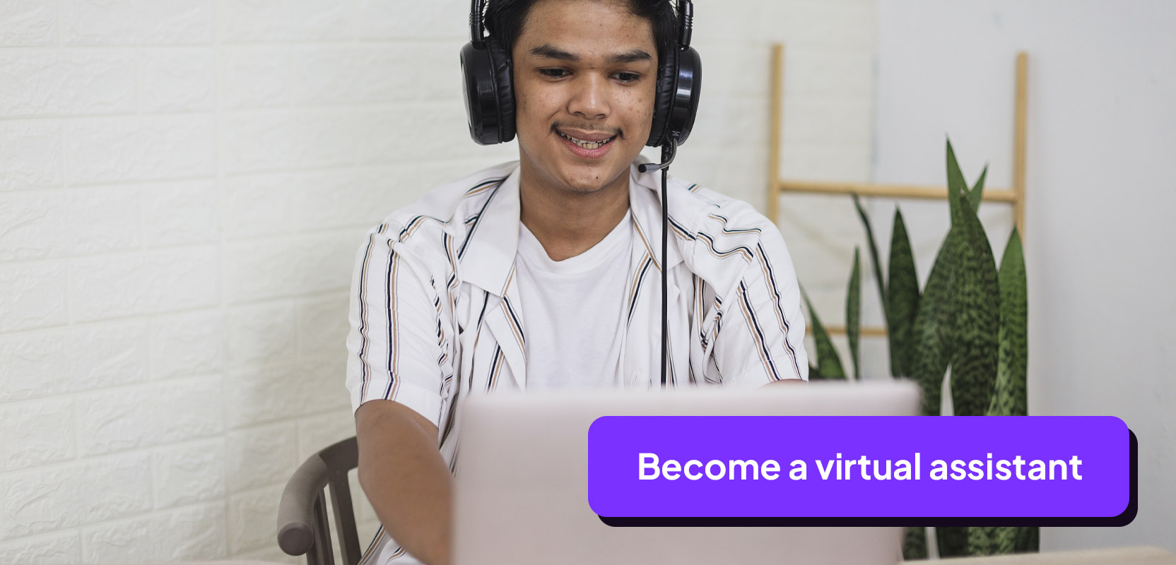 Teenage boy sitting at a laptop wearing headphones and working as a virtual assistant