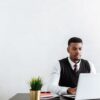 Black freelancer reading a negative review from a biased client.