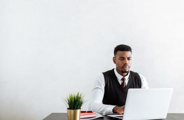 Black freelancer reading a negative review from a biased client.