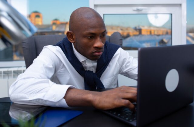 A Black remote employee researching side hustles to explore.