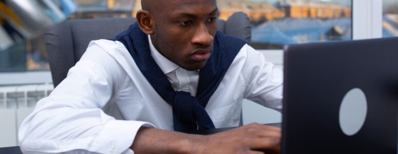 A Black remote employee researching side hustles to explore.