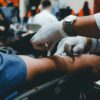 Close view of someone having blood drawn for donation.