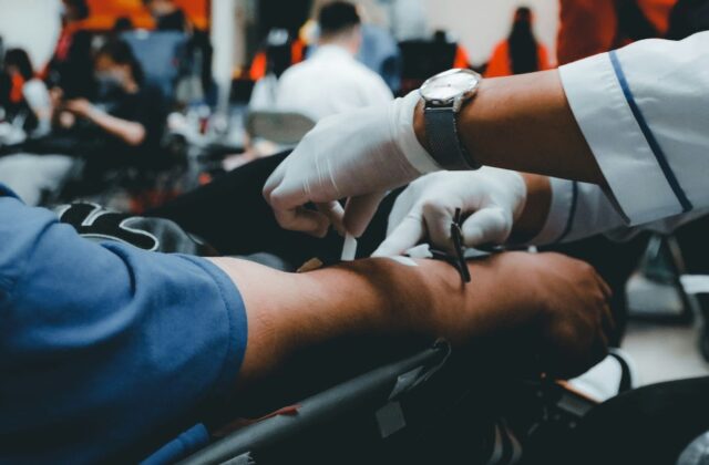 Close view of someone having blood drawn for donation.