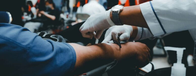 Close view of someone having blood drawn for donation.