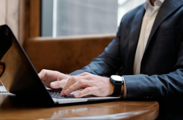 Boss tracking employees' activity on a laptop.