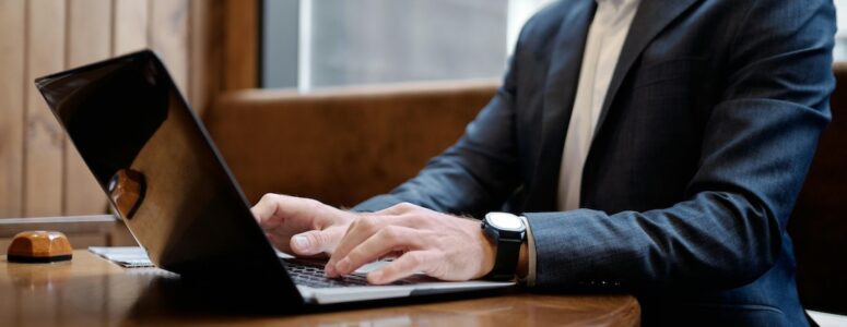 Boss tracking employees' activity on a laptop.