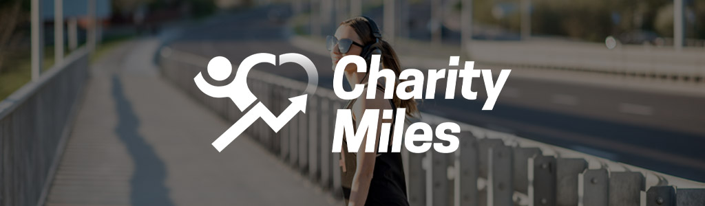 Charity Miles logo against a background showing someone walking on the side of a street