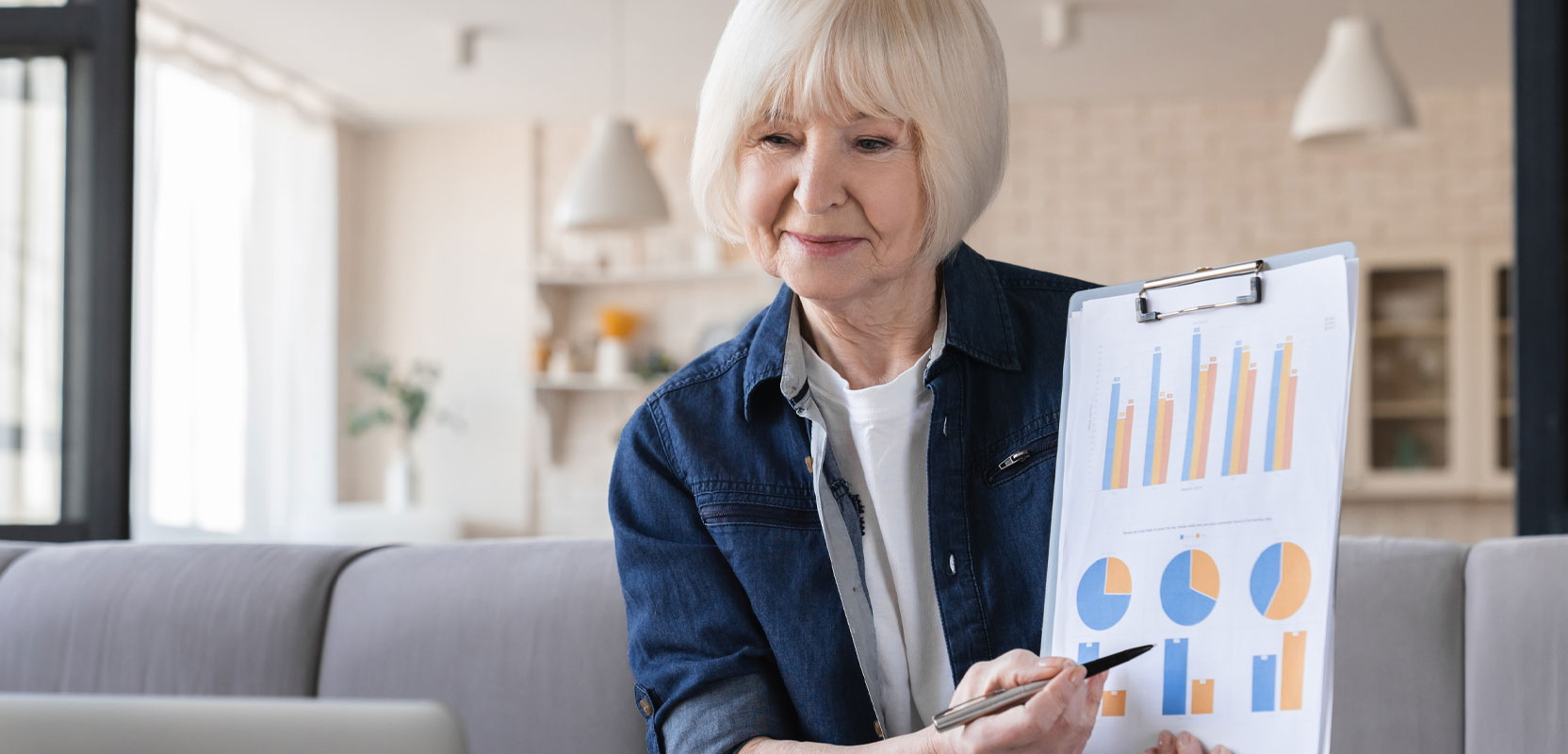 Retiree holding up a clipboard with graphs as part of her post-retirement consulting side hustle