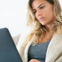 Contently freelancer working on her laptop.