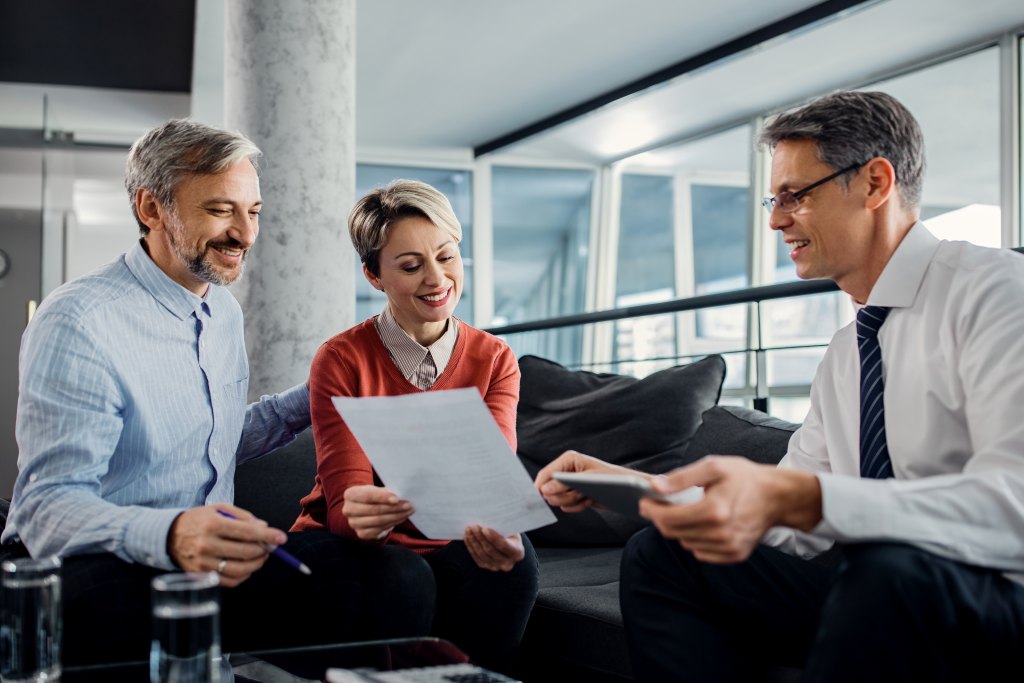 Happy couple meeting with financial advisor.