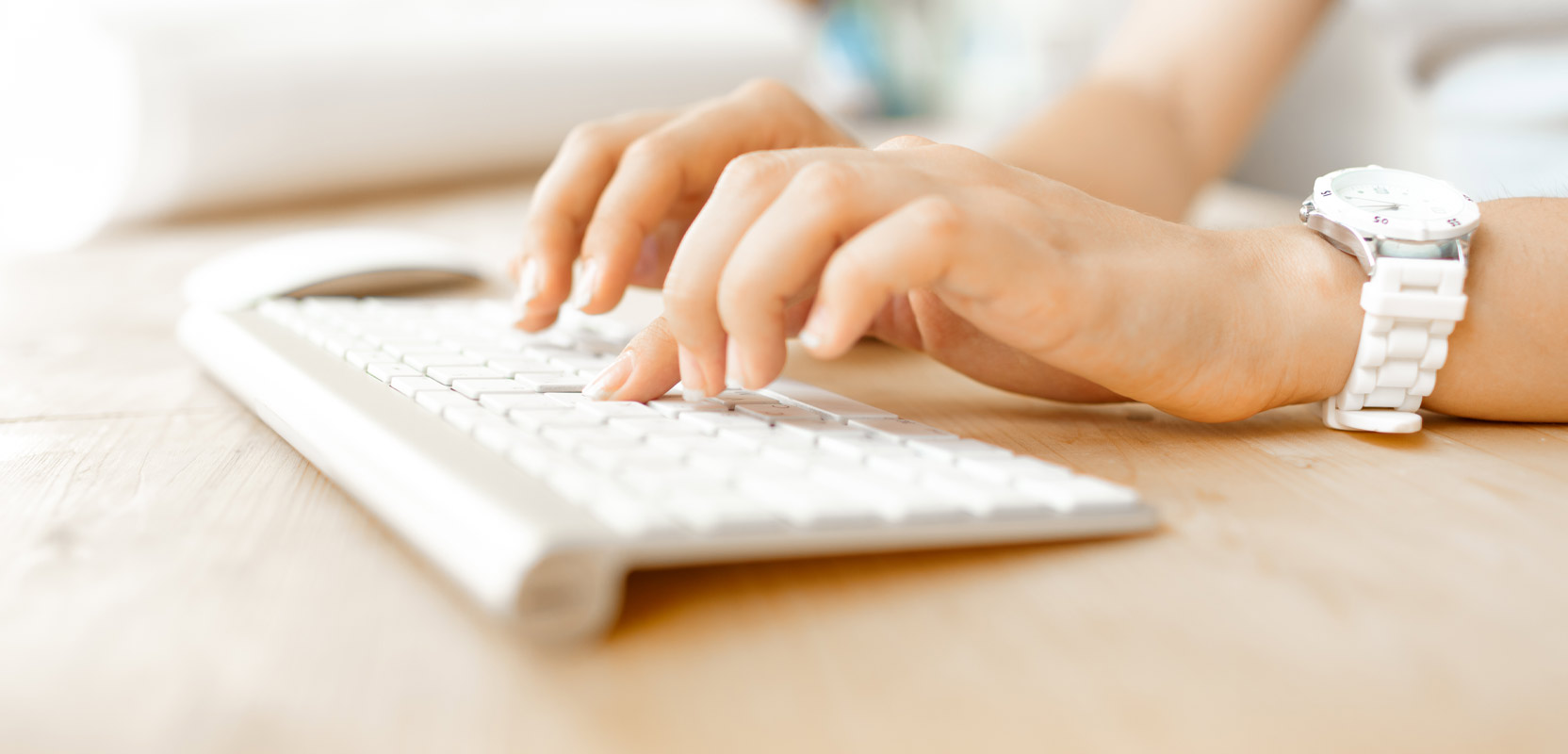 Closeup of a woman's hands as she works on a data entry side hustle from her home office