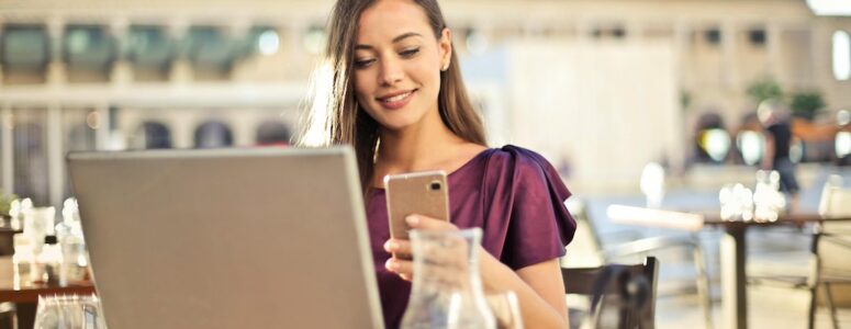 A digital nomad working from her laptop in a cafe.