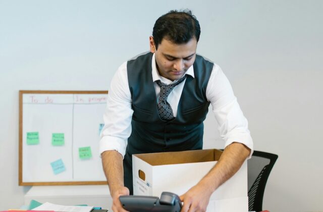 Employee packing up his desk after being laid off.