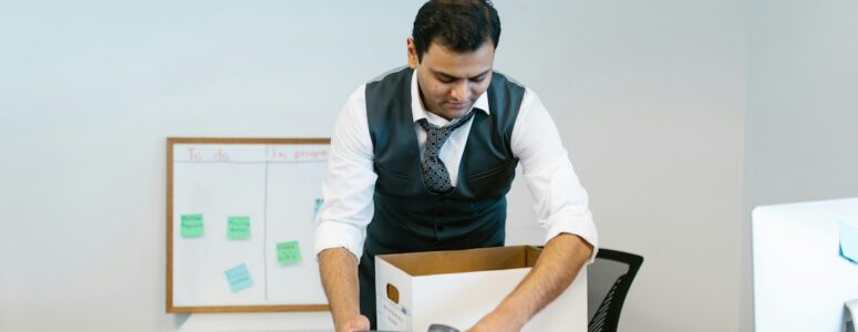 Employee packing up his desk after being laid off.