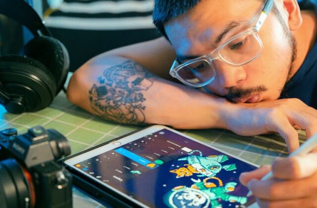 Freelance animator designing a character on his tablet.