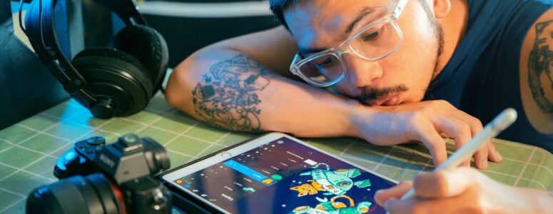 Freelance animator designing a character on his tablet.