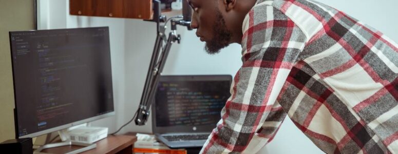 Freelance software developer writing code on a computer.