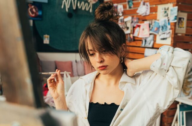 Gen Z artist painting on a canvas.
