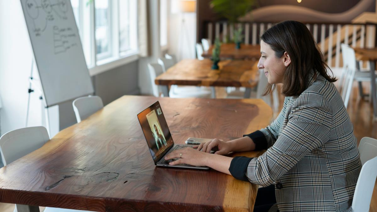 Virtual assistant chatting with a prospective client on her laptop.