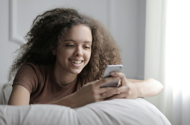 Woman getting paid to chat with people on her phone.