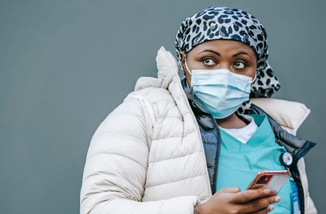 A gig nurse scrolling on her phone for shifts.