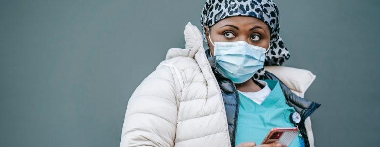 A gig nurse scrolling on her phone for shifts.