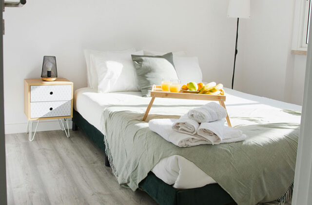 Bedroom with a well-made bed and dining tray in a Vrbo owner's home