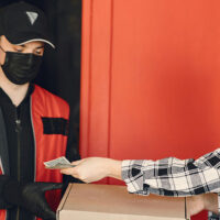 DoorDash driver receiving a payment from a customer.